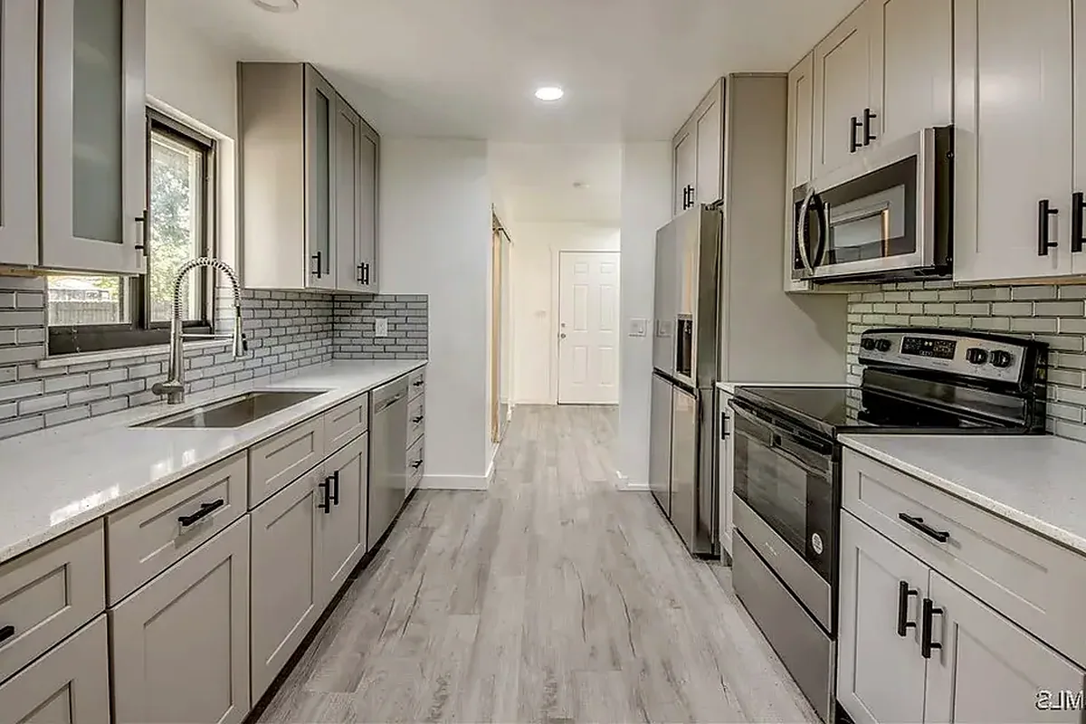 Port Charlotte finished flooring example: Kitchen flooring must connect cleanly with cabinets, walls, appliances and nearby rooms.