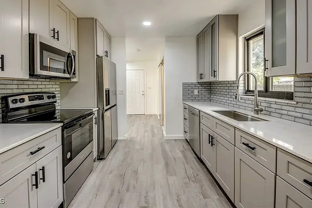 Venice finished flooring example: Kitchen floors need clean connections at cabinets, walls, appliances and nearby rooms.